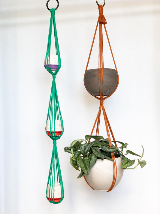 Two plant hangers.  One holds 3 pots the other holds 2 pots.  Shown in Kelly Green and Copper